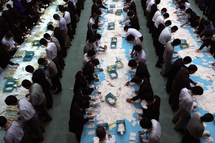 Electoral officials count ballots for the general election at the Himeji City Office in Himeji, Hyogo Prefecture, Japan, on O