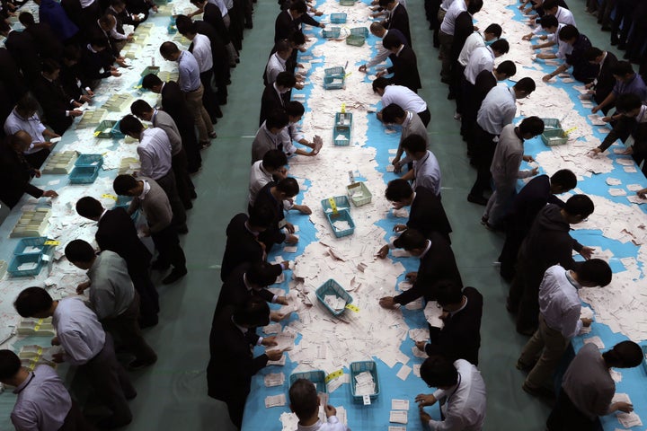 Electoral officials count ballots for the general election at the Himeji City Office in Himeji, Hyogo Prefecture, Japan, on Oct. 22, 2017.