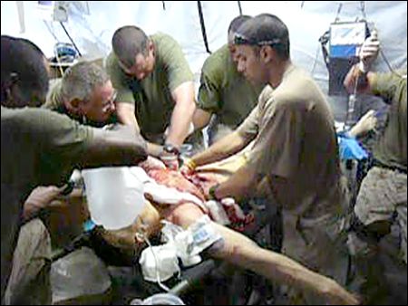 <p>Dr. Sudip Bose and his team work on an injured soldier in Iraq.</p>