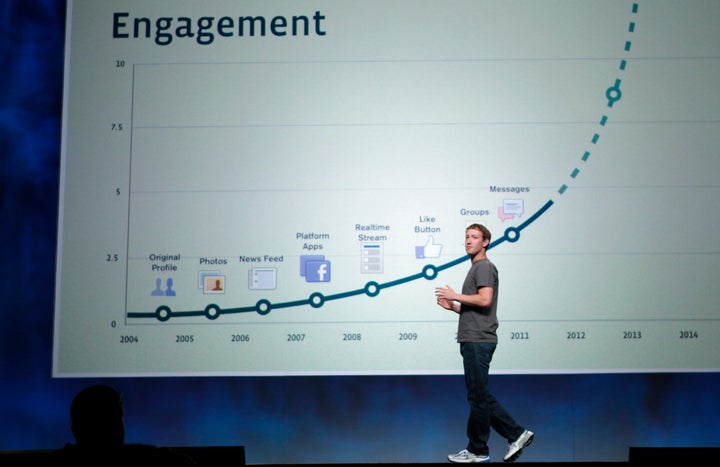 Facebook CEO Mark Zuckerberg stands in front of a slide boasting about user engagement during his address at the company's 2011 developers conference.