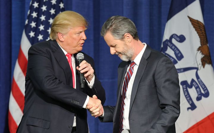 Then-presidential candidate Donald Trump (L) shakes hands with Jerry Falwell Jr. at a campaign rally in Council Bluffs, Iowa, on Jan. 31, 2016.