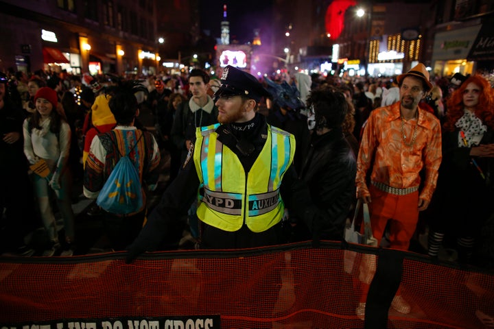 NYPD officers stand guard during the Halloween parade hours after a man driving a rental truck struck and killed eight people