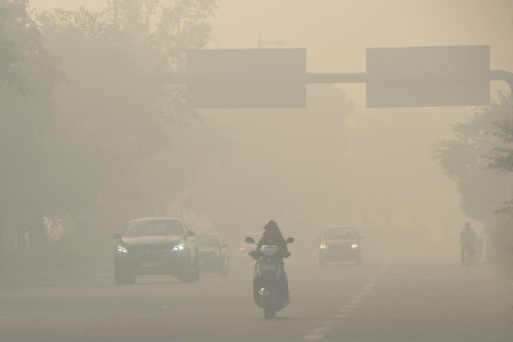 People commute amidst smog on a cold morning in New Delhi.