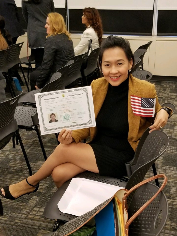 <p>Beanne de Guzman holding her new citizenship documents</p>