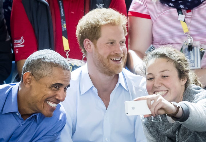 A woman takes a selfie with Obama and Prince Harry at the 2017 Invictus Games.