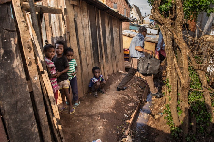 A doctor makes his way through the alleys of Antananarivo and toward the house of a plague victim. People who've been in contact with a plague case require twice-daily checkups for about a week.