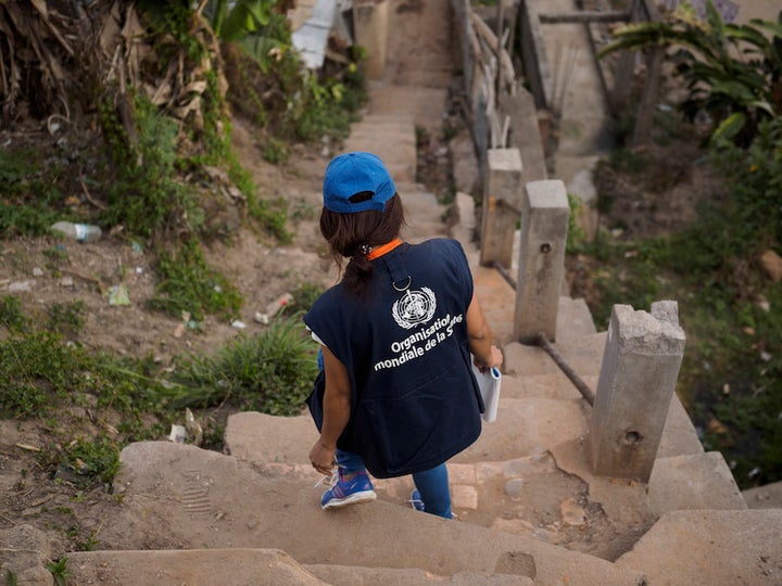 Harimahefa Razafimandimby, a Malagasy doctor helping to fight the plague epidemic, makes her way to a house visit.