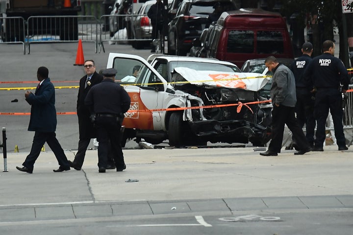 Investigators work around the wreckage of a Home Depot pickup truck a day after it was used in a terror attack in New York on November 1, 2017. 