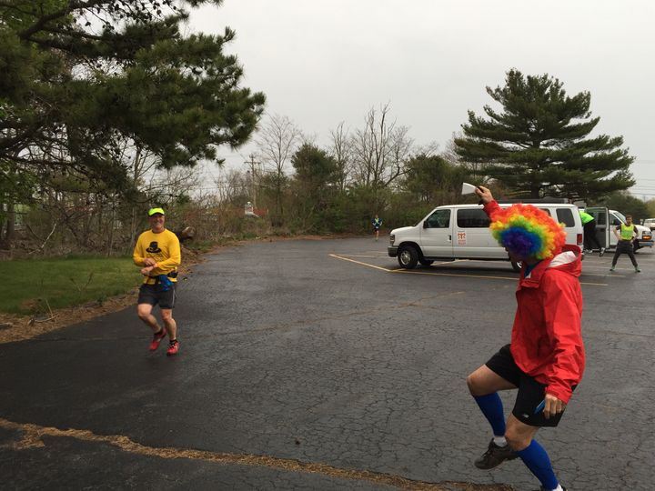 <p>Clown wig. Cowbell. Smiling runner. This spectator is clearly a veteran. </p>