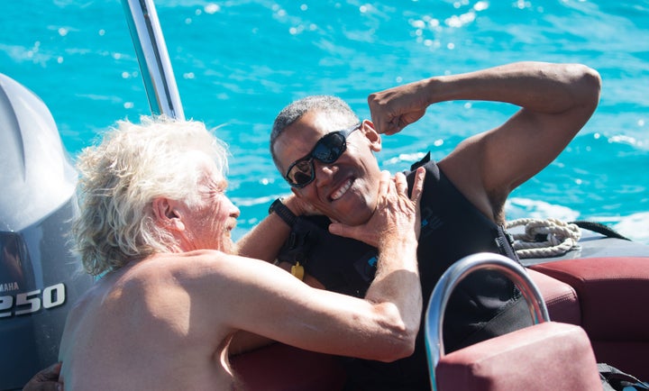 Former U.S. President Barack Obama and Richard Branson sit on a boat during Obama's holiday on Branson's Moskito island on Feb. 7, 2017. 