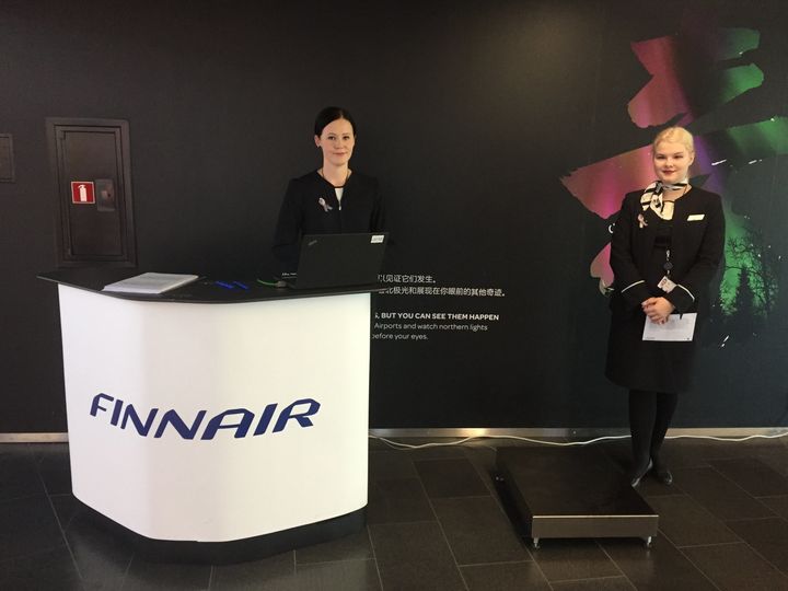 Finnair gate agents stand ready to welcome volunteer passengers during this week's tests at Helsinki Airport.