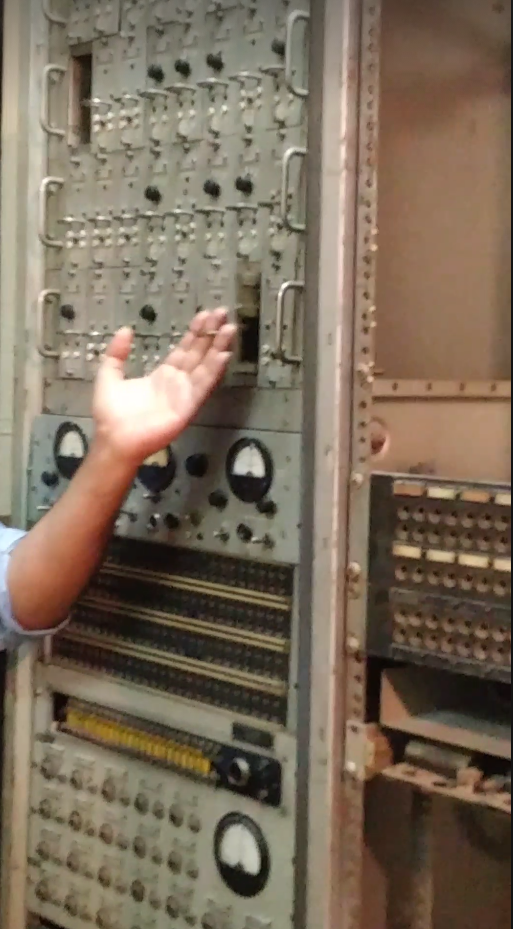 <p>Tour guide handles electronic equipment found within the former embassy.</p>