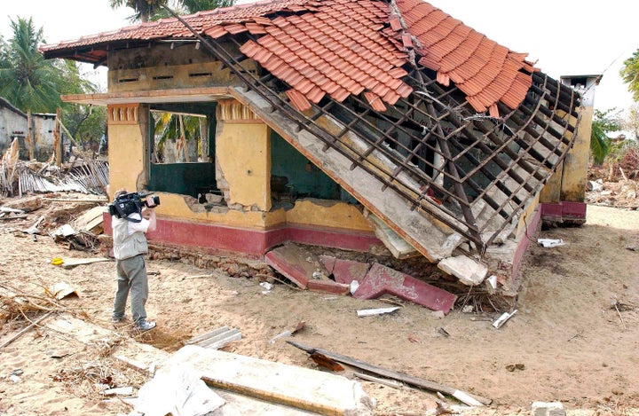<p> A cameraman films some of the destruction caused by the tsunami of 26 December 2004 in Mullaitivu, a town in northeastern Sri Lanka. The tsunami claimed the lives of thousands of members of this community.</p>