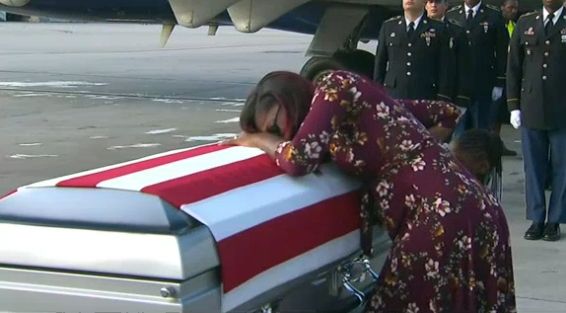 Myeshia Johnson, widow of U.S. Army Special Forces Sgt. La David Johnson, grieves over the casket holding her husband’s remains at Miami International Airport on October 17 .