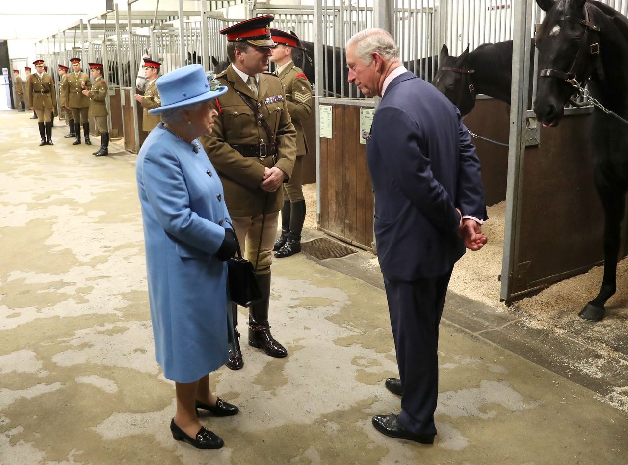 The Queen and Prince Charles on a tour of the Household Cavalry Mounted Regiment barracks near Hyde Park in London at the end of October.