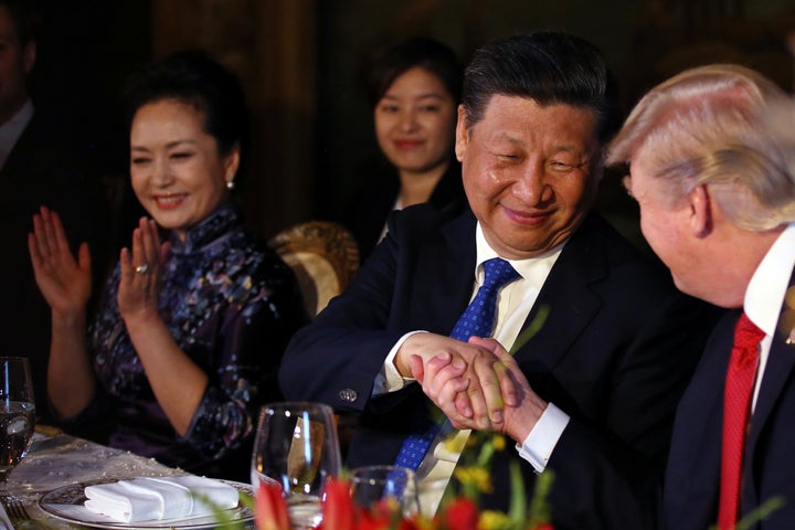 Chinese President Xi Jinping shakes trump's hand during a dinner at the start of a summit at the president's Mar-a-Lago estat