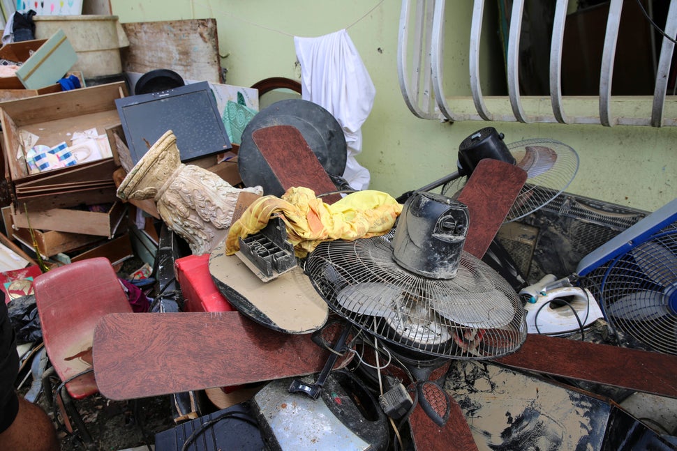 Juan Medina-Dishmey and his wife, Juana Ferrera, cleared out damaged belongings from their home in Valle Hill, Canóvan