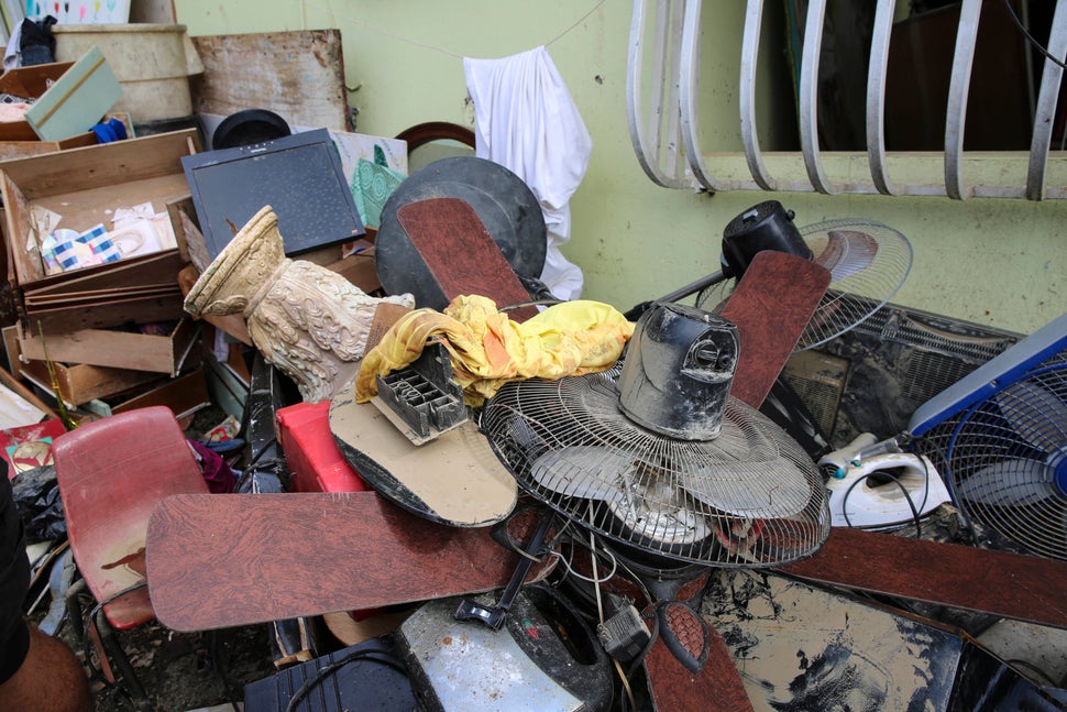 Juan Medina-Dishmey and his wife, Juana Ferrera, cleared out damaged belongings from their home in Valle Hill, Canóvanas, Puerto Rico. They told HuffPost they feared it may all be contaminated with the leptospirosis bacteria.