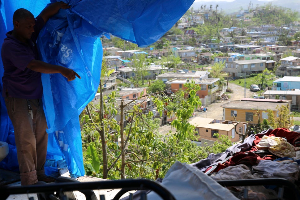 Danny Guerrero Herrera in mid-October shows HuffPost what's behind the blue tarp a charitable organization gave him after Hur