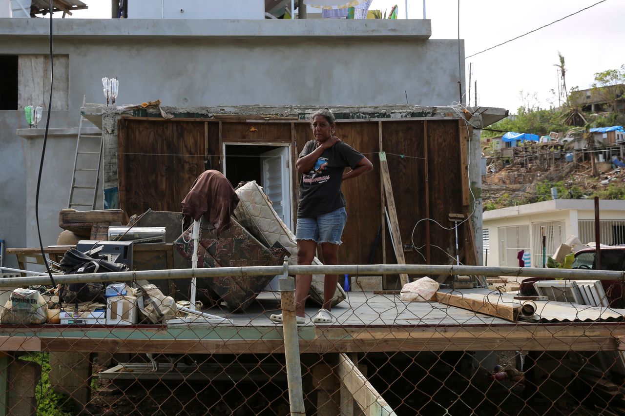 A woman stands in the middle of what used to be her home in Canóvanas, Puerto Rico, on Oct. 14, 2017.