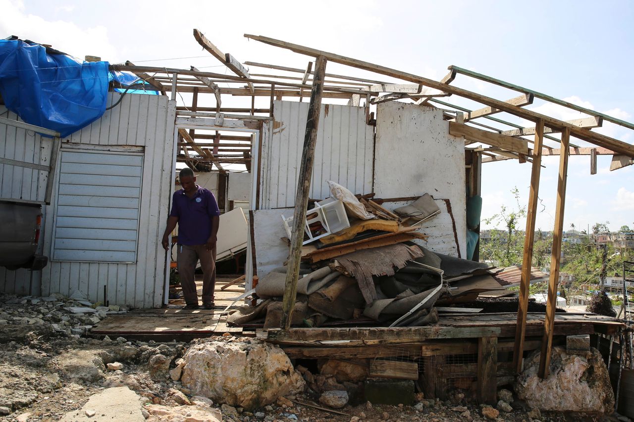Guerrero Herrera stands in front of what's left of his home.