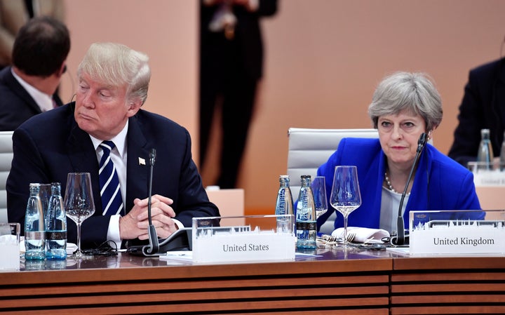 Trump and British Prime Minister Theresa May wait at the start of the first working session of the G-20 meeting in Hamburg, Germany, on July 7.