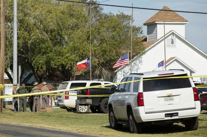 Law enforcement officials gather near the First Baptist Church.