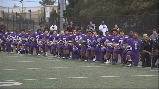 The entire Garfield High School football team knelt during the national anthem protesting social injustice.