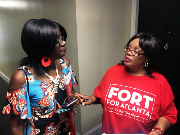 Deborah Arnold (right), a Fort campaign volunteer, speaks with Shelby Porter while canvassing the mixed-income City Views high-rise.