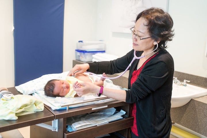 A midwife tends to a newborn in Canada.