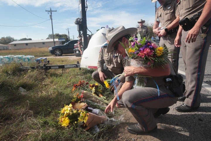 Police move flowers placed at a barricade near the First Baptist Church of Sutherland Springs on Monday. Gunman Devin Patrick Kelley killed 26 people and wounded 20 others when he opened fire during a Sunday service at the Texas church.