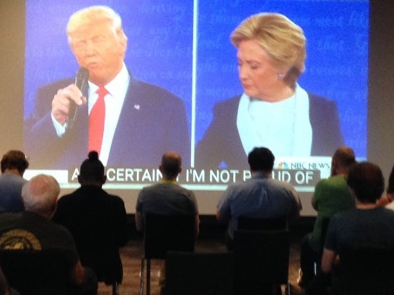 Voters watch the presidential debate in a public library.