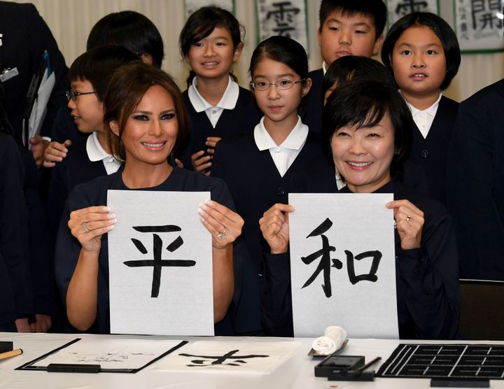 U.S. first lady Melania Trump and Akie Abe, wife of Japanese Prime Minister Shinzo Abe, write the word "peace" in Japanese.