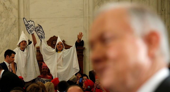 Protesters dressed as Klansmen disrupt the start of a Senate Judiciary Committee confirmation hearing for U.S. Attorney General nominee Jeff Sessions on Jan. 10, 2017.