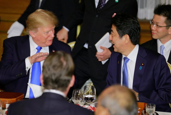 U.S. President Donald Trump talks with Japanese Prime Minister Shinzo Abe at a welcome dinner at Tokyo's Akasaka Palace on Nov. 6, 2017.