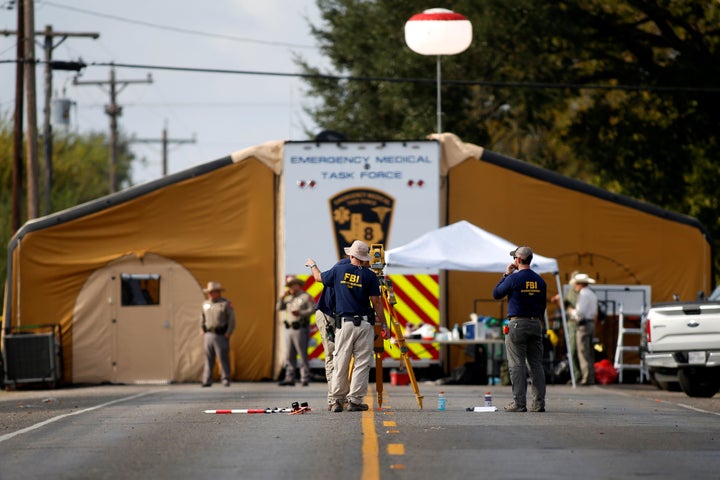 Law enforcement officers investigate the site of the shooting at the First Baptist Church in Sutherland Springs, Texas.