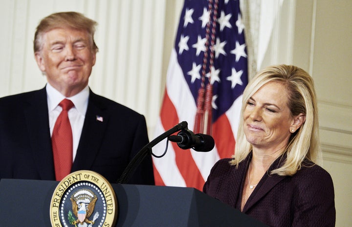 President Donald Trump stands beside Kirstjen Nielsen, his nominee for homeland security secretary.