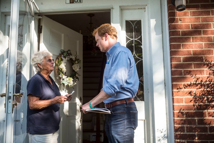 Democrat Chris Hurst, right, canvasses in Blacksburg, Virginia, in July. Hurst unseated Republican Joseph Yost on Tuesday.