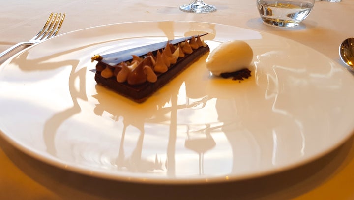 Artisan chocolate and hazelnut dessert garnished with gold leaf