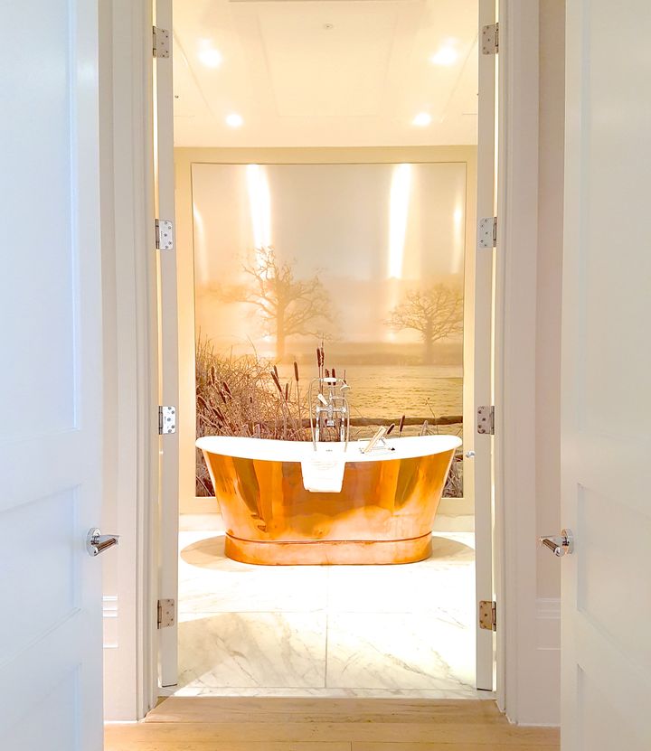 Impossibly deep copper bathtub in the ultra-luxe suite bathrooms with heated floors and Mitchell and Peach toiletries