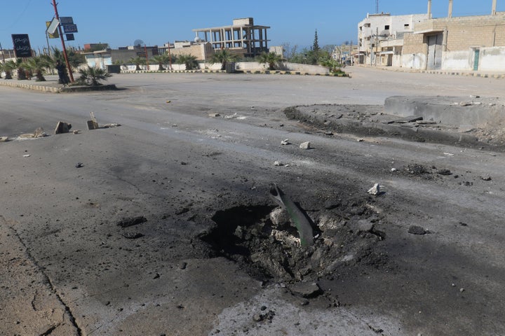 A crater is seen at the site of an airstrike, after what rescue workers described as a suspected gas attack in the town of Kh