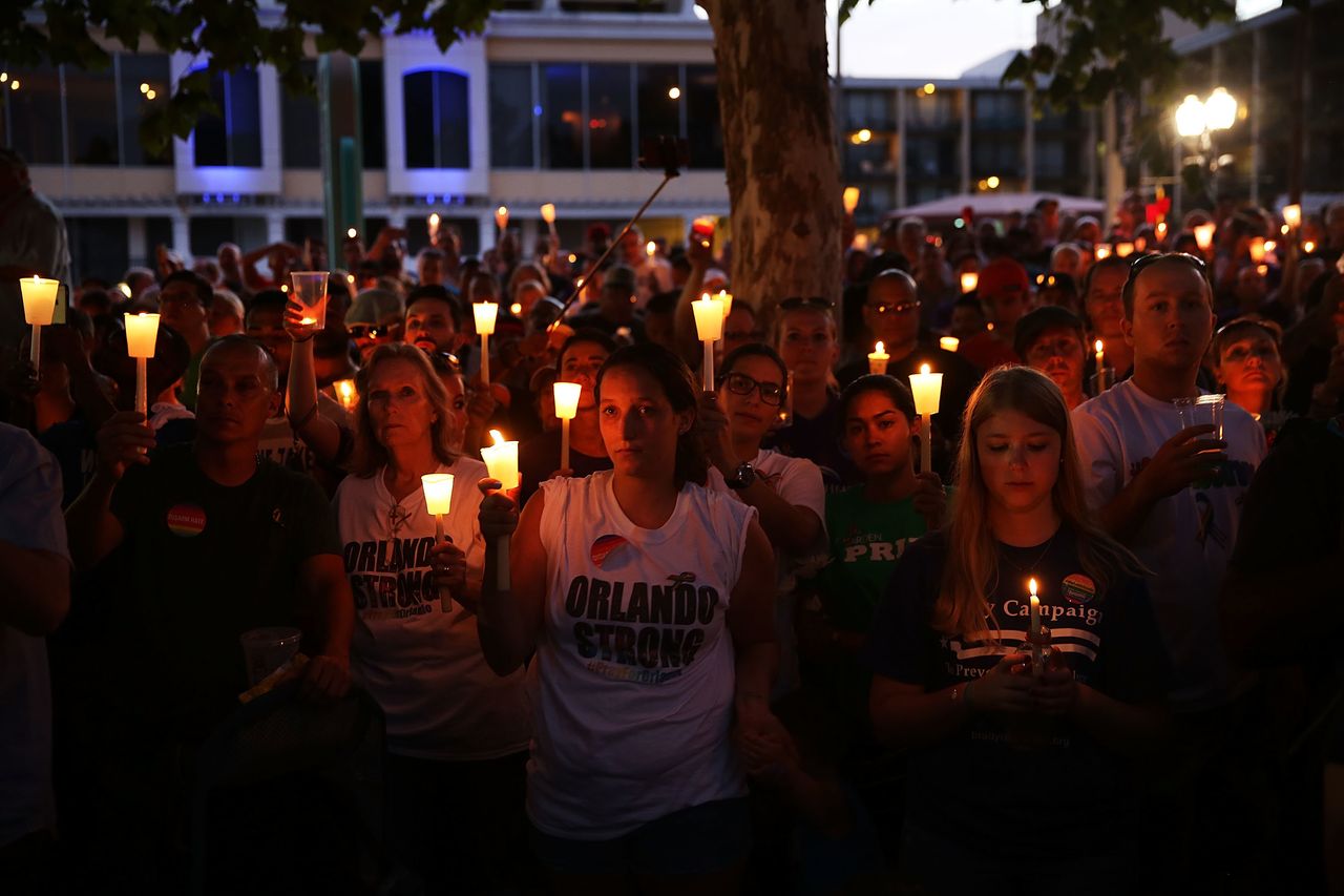 People attend a memorial service on June 19, 2016, in Orlando, Florida.