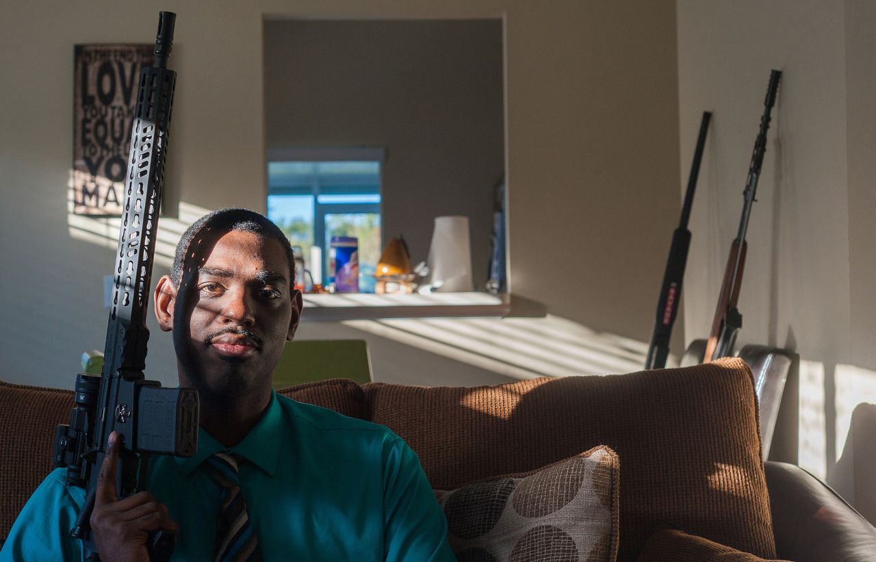 Carlton LeFlore poses with an Armalite AR-10 rifle at his home in Orlando, Florida.