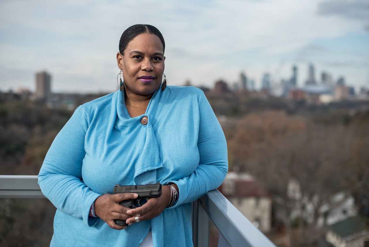 Toria Boldware of Minneapolis, poses with "Shelby," her Smith and Wesson .40-caliber Shield gun at her apartment in Minneapolis.