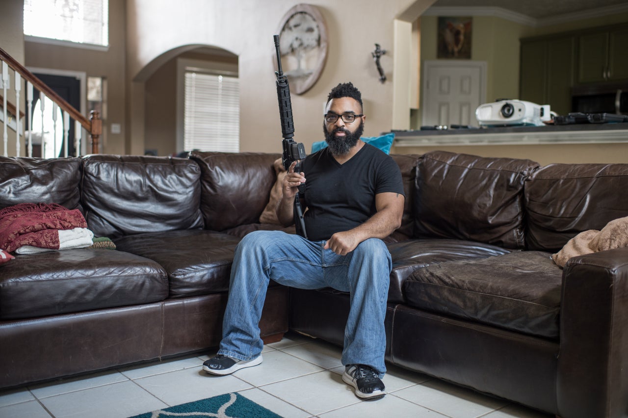 Thomas Moore poses for a portrait in his home with his LWRC .223/.556 MS Rifle with EOTech sights in Houston, Texas.