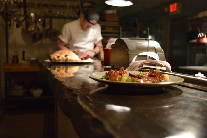 <p>Octopus with soft herbs and fried garlic at Hog & Hominy</p>