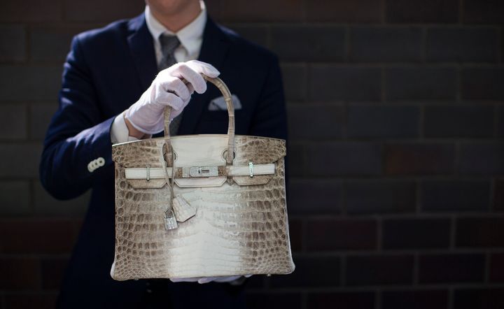 An employee holds an Hermes diamond and Himalayan Nilo Crocodile Birkin handbag at Heritage Auctions offices in Beverly Hills, CA on Sept. 22, 2014. The handbag has 242 diamonds with a total of 9.84 carats.