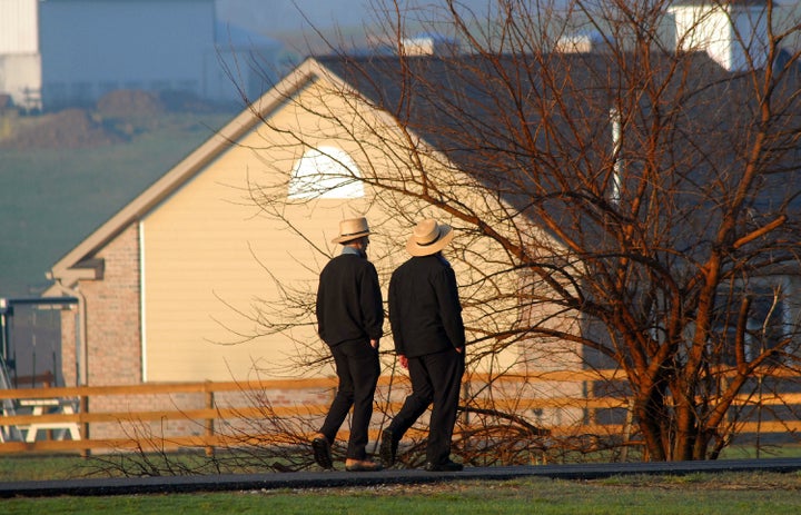 Amish men pass the newly built schoolhouse April 2, 2007 in Nickel Mines, Pennsylvania.