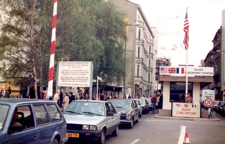 Heavy, unimpeded traffic passing through famous “Checkpoint Charlie” in and out of East Berlin a few weeks after the Wall came down
