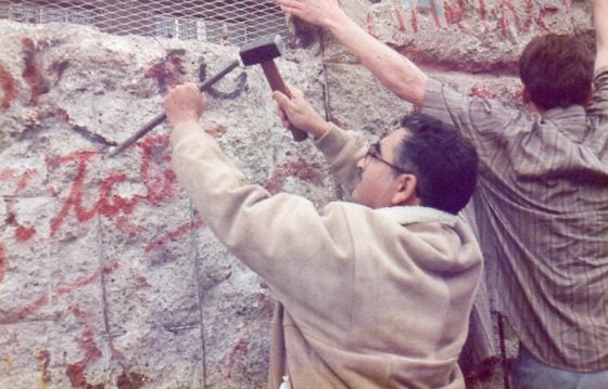 <em>Author chipping away at the Berlin Wall</em>
